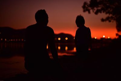 Silhouette men against sky during sunset