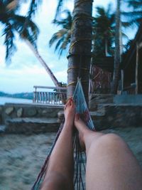 Low section of person relaxing on hammock