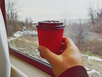 Midsection of woman holding coffee cup