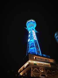 Low angle view of illuminated building against sky at night