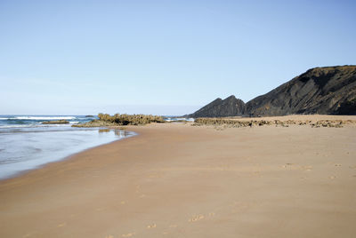 Scenic view of beach against clear sky