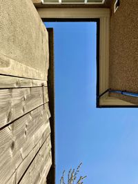 Low angle view of building against clear blue sky