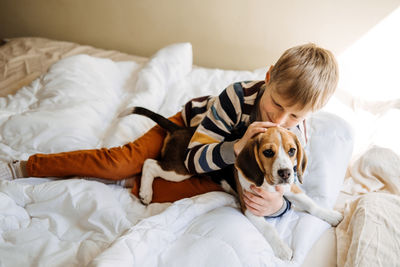 Dog relaxing on bed at home