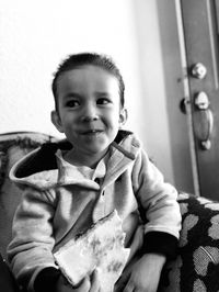 Portrait of cute boy sitting at home