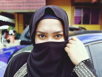 Close-up portrait of young woman wearing burkha