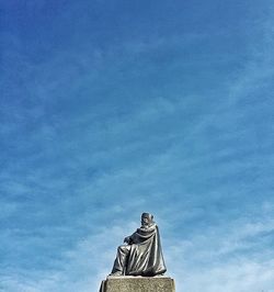 Low angle view of statue against cloudy sky