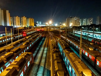 High angle view of railroad tracks in city at night