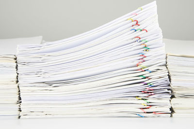 Close-up of stacked files on desk in office