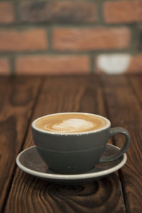 Close-up of cappuccino served on table