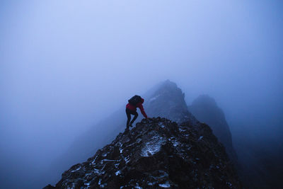 Low angle view of people walking on mountain