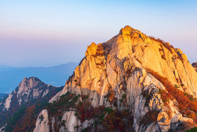 Rock formations on mountain against sky