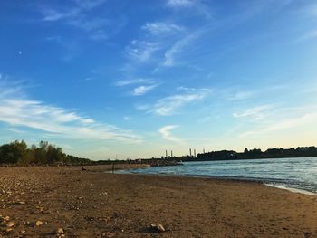 Scenic view of beach against blue sky