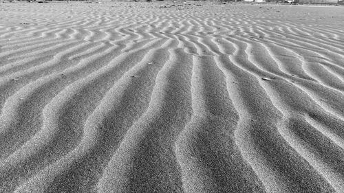 Full frame shot of tire tracks on sand