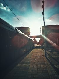 Railroad station in city against sky