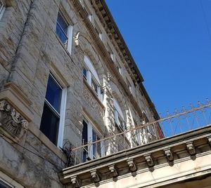 Low angle view of buildings against blue sky