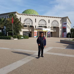 Man standing by building in city