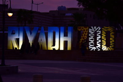 Graffiti on illuminated city at night