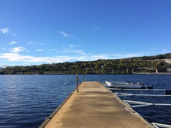 Narrow jetty leading to calm lake