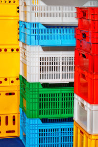 Plastic multi colored boxes stacked on top of each other.