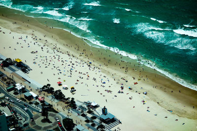 Aerial view of people at beach by city