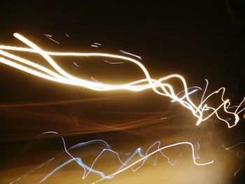 Light trails against sky at night