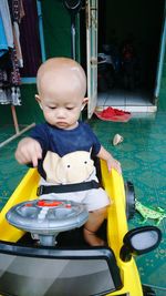 Boy sitting in toy car