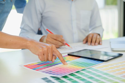 Cropped image of business people working in office