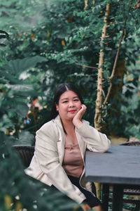 Portrait of a smiling young woman sitting outdoors