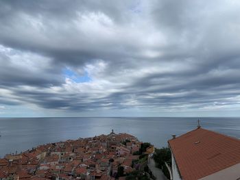 Panoramic view of sea and buildings against sky