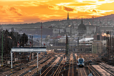 Railroad tracks against sky during sunset