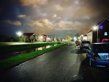 Cars on road against sky in city at night