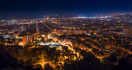 Aerial view of city lit up at night