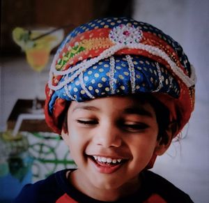 Close-up of smiling boy wearing headdress