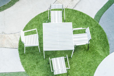 High angle view of empty chair in yard