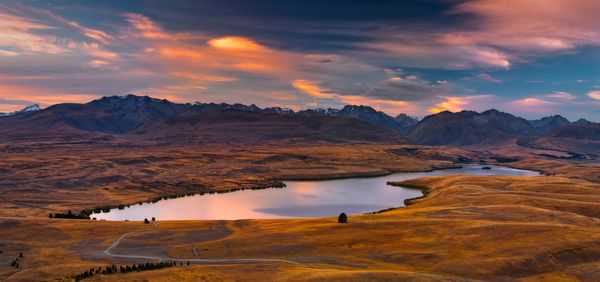 Scenic view of lake against sky during sunset