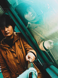 Portrait of a young man holding train