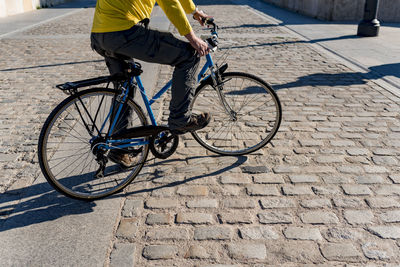 Unrecognizable man riding bicycle in the city