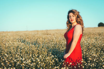 Young woman standing on field