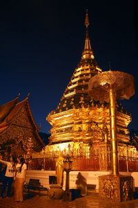Illuminated temple against sky at night