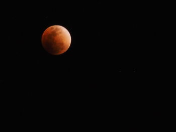Low angle view of moon against clear sky at night