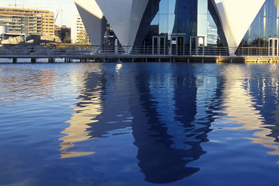 Bridge over river against buildings in city