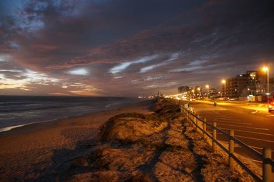 Scenic view of beach against sky at night