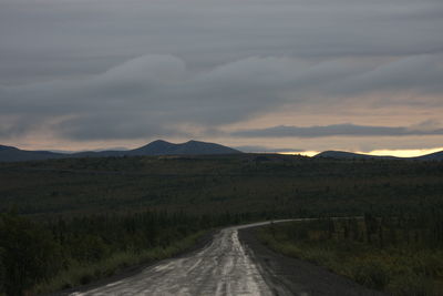 Empty road along countryside landscape