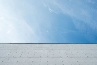 Concrete wall against blue sky