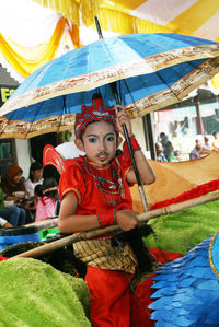 Portrait of woman holding umbrella