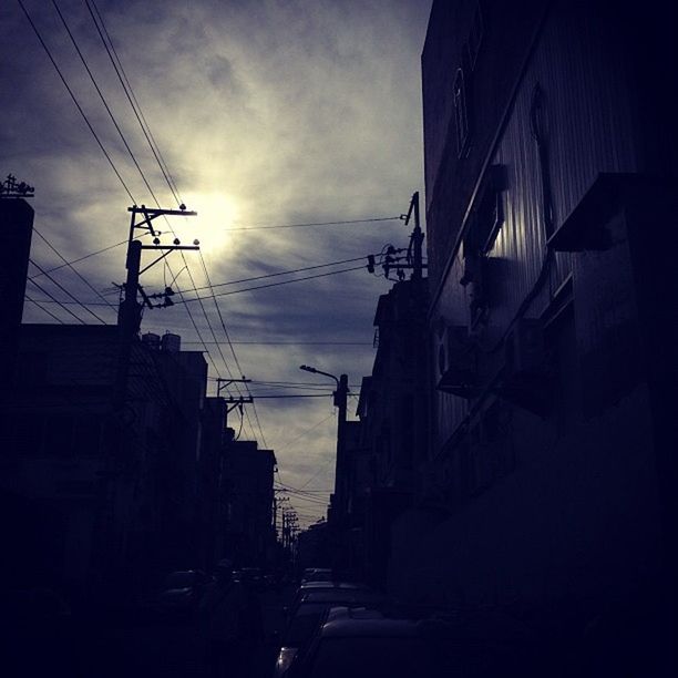 building exterior, power line, built structure, architecture, electricity pylon, sky, cable, electricity, power supply, transportation, low angle view, city, street, connection, building, silhouette, residential structure, residential building, cloud - sky, power cable