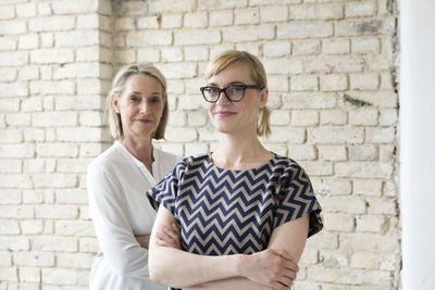 Mature businesswoman working with younger colleague in office