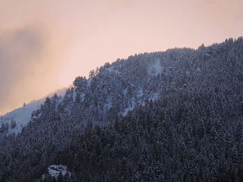 Scenic view of snowcapped mountain against sky at sunset