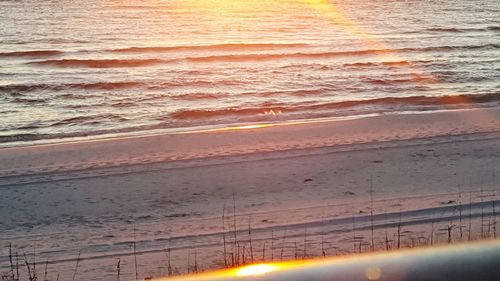 Scenic view of beach against sky during sunset