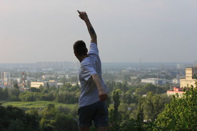 Rear view of man looking at cityscape